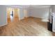 Living room featuring new floors, fireplace, and access to dining area and staircase at 3697 E Bay St, Duluth, GA 30096