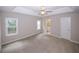 Spacious main bedroom with tray ceiling, ceiling fan, and access to the ensuite bathroom at 3697 E Bay St, Duluth, GA 30096