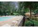 Community pool with ample seating, surrounded by lush greenery at 3697 E Bay St, Duluth, GA 30096