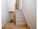 Staircase with carpeted steps, wooden handrail, and neutral walls leading to upper level, blending style with functionality at 3697 E Bay St, Duluth, GA 30096