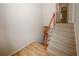 Carpeted staircase with wooden banister leading to the upper level of the house, seamlessly connecting different floors at 3697 E Bay St, Duluth, GA 30096
