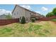 Well-maintained backyard with a patio, lush lawn, and wooden fence at 4090 Danbury Farms Dr, Cumming, GA 30040