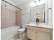 Cozy bathroom features a shower-tub combo and a neutral-toned vanity with white cabinets at 4090 Danbury Farms Dr, Cumming, GA 30040