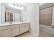 Well-lit bathroom with double vanity, tile floors, and a separate shower and tub at 4090 Danbury Farms Dr, Cumming, GA 30040