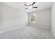 Bedroom with gray carpet, neutral walls, a ceiling fan, and a window at 4090 Danbury Farms Dr, Cumming, GA 30040