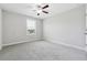 Bedroom with gray carpet, neutral walls, a ceiling fan, and a window at 4090 Danbury Farms Dr, Cumming, GA 30040