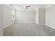 Bedroom featuring neutral carpet, light walls, a ceiling fan and natural light from a window at 4090 Danbury Farms Dr, Cumming, GA 30040
