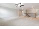 A large bonus room with carpet and staircase with wood banister at 4090 Danbury Farms Dr, Cumming, GA 30040
