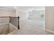 Expansive, light-filled upstairs bonus room features neutral carpeting, trimwork and a view from the stairwell at 4090 Danbury Farms Dr, Cumming, GA 30040