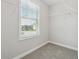 Walk-in closet includes carpet, wire shelving, and a window for natural light at 4090 Danbury Farms Dr, Cumming, GA 30040