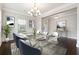 Well-lit dining room with chandelier, wainscoting, and ample natural light at 4090 Danbury Farms Dr, Cumming, GA 30040