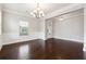Formal dining room with chandelier, wainscoting, and ample natural light at 4090 Danbury Farms Dr, Cumming, GA 30040
