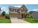 Beautiful two-story brick home with a well-maintained front lawn and an attached two-car garage at 4090 Danbury Farms Dr, Cumming, GA 30040