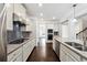 Bright kitchen with granite countertops, stainless steel appliances, and gray subway tile backsplash at 4090 Danbury Farms Dr, Cumming, GA 30040