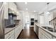 Well-equipped kitchen featuring modern appliances, a gas cooktop, and sleek countertops at 4090 Danbury Farms Dr, Cumming, GA 30040