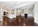 Open concept kitchen and living room featuring stainless steel appliances and hardwood floors at 4090 Danbury Farms Dr, Cumming, GA 30040