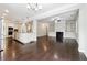 Open living space featuring a fireplace, built-in shelving, and hardwood floors at 4090 Danbury Farms Dr, Cumming, GA 30040