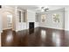 Elegant living room featuring hardwood floors, built-in shelves, and a fireplace at 4090 Danbury Farms Dr, Cumming, GA 30040