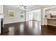 Bright living room featuring hardwood floors, fireplace, and ample natural light at 4090 Danbury Farms Dr, Cumming, GA 30040