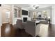 Bright living room features built-in shelving, fireplace, ceiling fan and hardwood floors at 4090 Danbury Farms Dr, Cumming, GA 30040