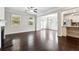 Bright living room featuring hardwood floors, a fireplace, and an open-concept layout at 4090 Danbury Farms Dr, Cumming, GA 30040
