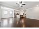Open-concept living room with hardwood floors leading into the kitchen at 4090 Danbury Farms Dr, Cumming, GA 30040