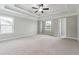 Spacious main bedroom with ceiling fan and large windows for ample natural light at 4090 Danbury Farms Dr, Cumming, GA 30040
