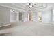 An expansive main bedroom features tray ceilings, ceiling fan, and connecting rooms at 4090 Danbury Farms Dr, Cumming, GA 30040