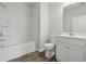 Clean, well-lit bathroom with white vanity, bathtub/shower combination, and wood-look flooring at 2182 Talmai Dr, Snellville, GA 30078
