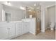 Bright bathroom featuring double vanity, large mirror, and walk-in shower with glass door at 2182 Talmai Dr, Snellville, GA 30078