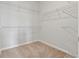 Walk-in closet with neutral carpet and white, built-in wire shelving for optimal storage at 2182 Talmai Dr, Snellville, GA 30078