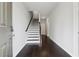 Welcoming entryway with hardwood floors and staircase leading to the upper level at 2182 Talmai Dr, Snellville, GA 30078