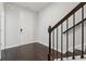 Bright entryway with hardwood floors, white door, staircase with dark wood handrail and risers at 2182 Talmai Dr, Snellville, GA 30078