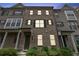 Traditional brick townhome featuring multi-pane windows, dark shutters, and covered entryways at 2182 Talmai Dr, Snellville, GA 30078