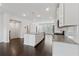 Open-concept kitchen with granite countertops, white cabinets, stainless steel appliances, and hardwood floors at 2182 Talmai Dr, Snellville, GA 30078