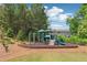 Outdoor playground with slide, climbing bars, and benches surrounded by mature trees at 2182 Talmai Dr, Snellville, GA 30078