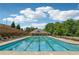 Community pool featuring clear water, multiple lounge chairs, and shady canopy at 2182 Talmai Dr, Snellville, GA 30078