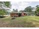 Brick home featuring a spacious backyard with a fire pit, perfect for outdoor enjoyment at 2614 Princess Se Ln, Marietta, GA 30067