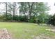 Expansive backyard featuring lush lawn and mature trees, ideal for outdoor activities at 2614 Princess Se Ln, Marietta, GA 30067