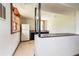 View of the basement kitchen with a white fridge, dark cabinets and countertops, and wood-trimmed windows at 2614 Princess Se Ln, Marietta, GA 30067