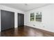 Bright bedroom featuring hardwood floors, a large window, and ample closet space at 2614 Princess Se Ln, Marietta, GA 30067