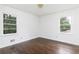 Bedroom with hardwood floors and two windows providing natural light and a view of the outdoors at 2614 Princess Se Ln, Marietta, GA 30067