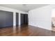 Spacious bedroom featuring hardwood floors, three closets, and a glimpse into an attached bathroom at 2614 Princess Se Ln, Marietta, GA 30067