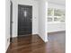 Inviting entryway featuring gleaming hardwood floors and a modern black door at 2614 Princess Se Ln, Marietta, GA 30067