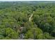 Aerial view of a home nestled in a lush, green forested area, offering privacy and tranquility at 350 Westchester Way, Canton, GA 30115