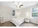 Cozy bedroom with neutral walls, ceiling fan, and windows providing natural light at 350 Westchester Way, Canton, GA 30115
