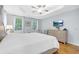 Spacious primary bedroom with hardwood floors, a tray ceiling, and multiple windows at 350 Westchester Way, Canton, GA 30115