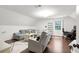 Spacious bonus room features a comfortable seating area, a desk, and ample natural light from a large window at 350 Westchester Way, Canton, GA 30115