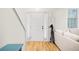 Bright foyer with hardwood floors, a coat rack, and views into the living area at 350 Westchester Way, Canton, GA 30115