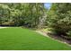 Well-maintained front yard with lush lawn and mature trees offering privacy at 350 Westchester Way, Canton, GA 30115